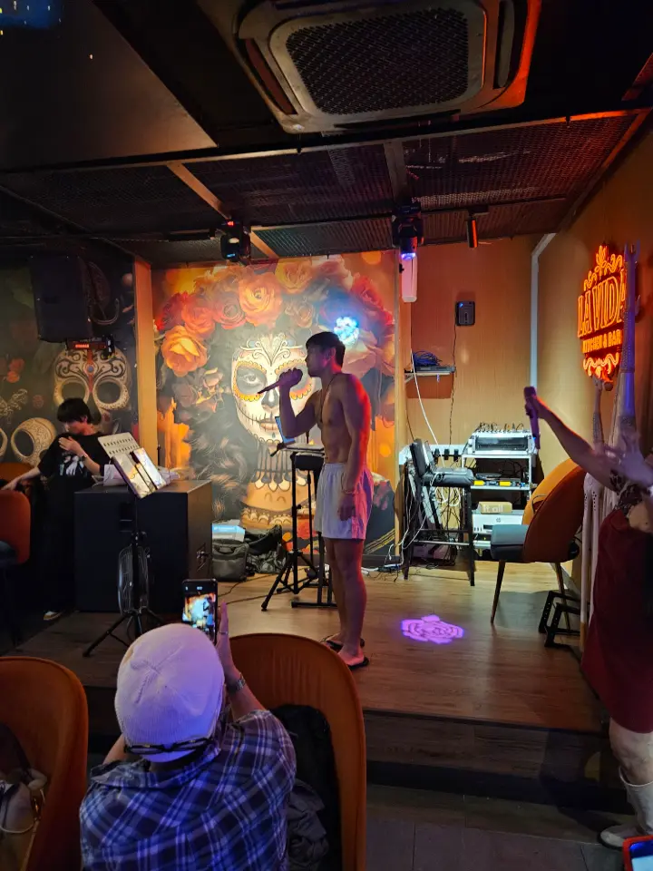Guests in a booth under neon