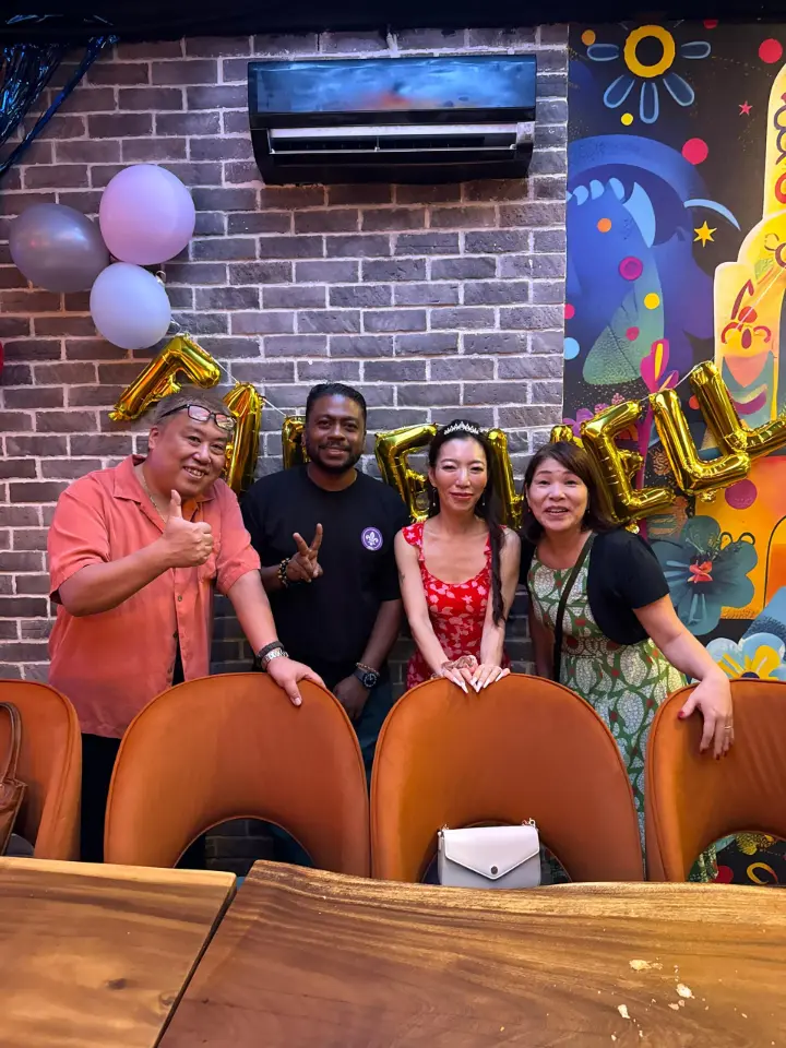 Group dressed up under colourful neon, celebratory atmosphere
