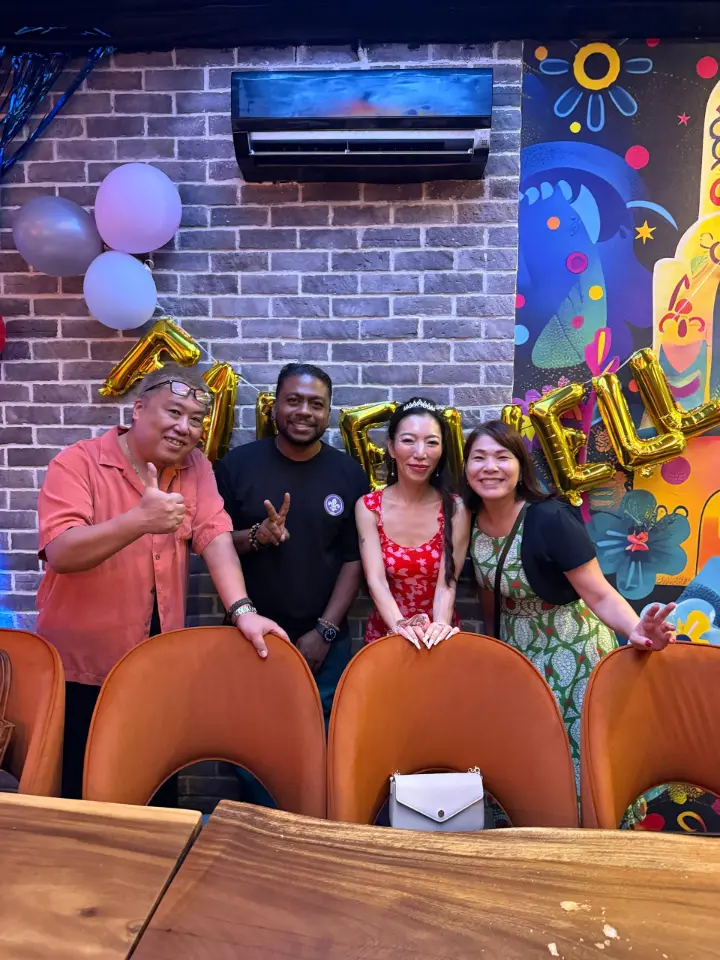 Guests dancing under vibrant neon signage